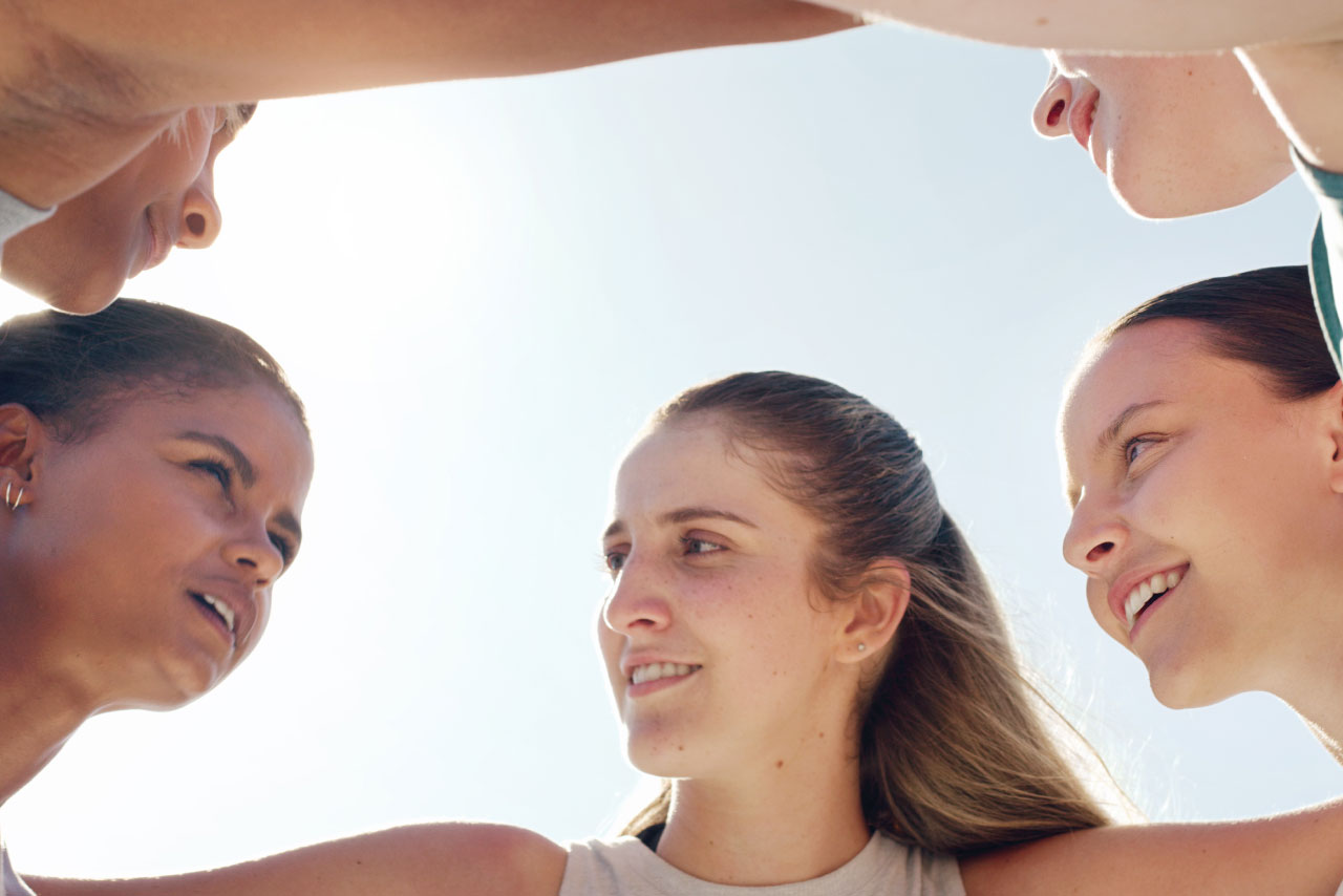 Group of girls huddled in a cricle